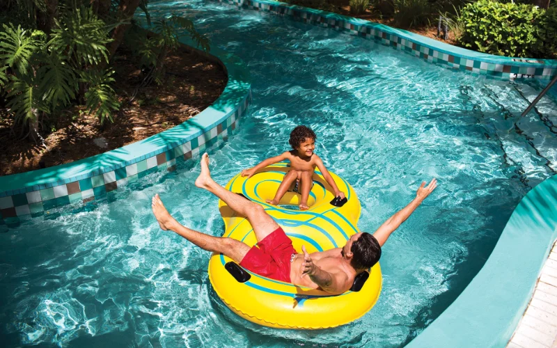 Father and son in the lazy river at Tidal Cove