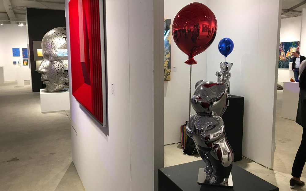 Sculptures of silver bears holding red and blue balloons at Art Basel's Spectrum Miami event Sculptures of silver bears holding red and blue balloons at Art Basel's Spectrum Miami event