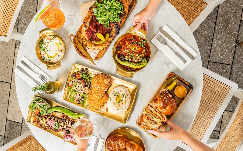 Table filled with Motek’s signature brunch items Table filled with Motek’s signature brunch items