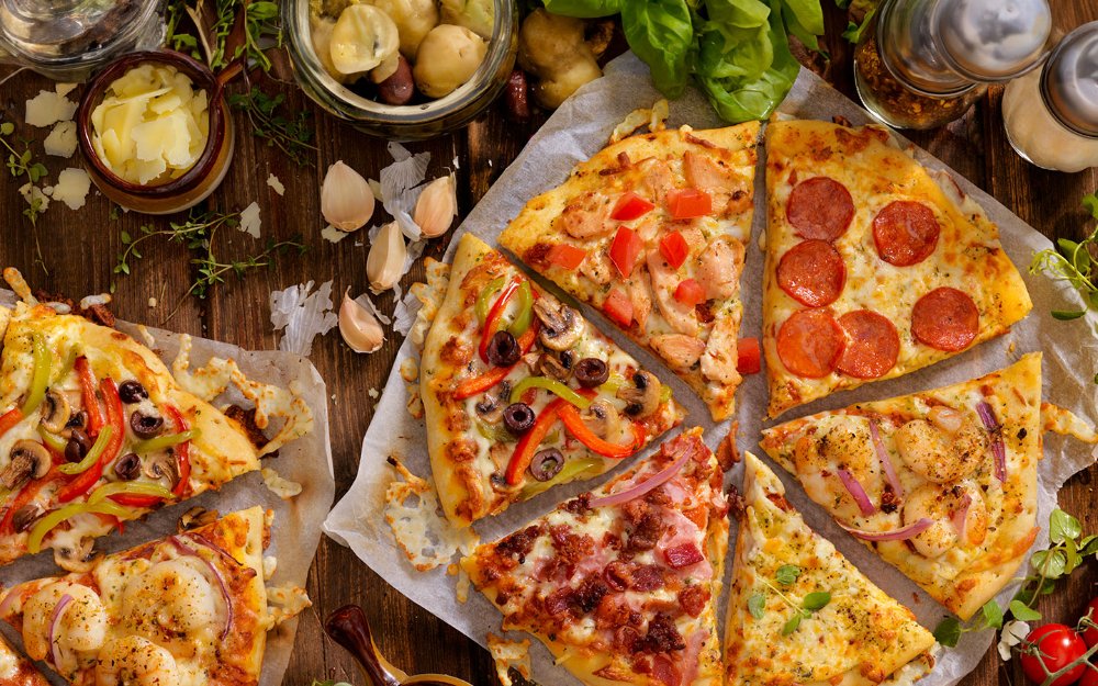 Pizzas with meats, veggies and cheese