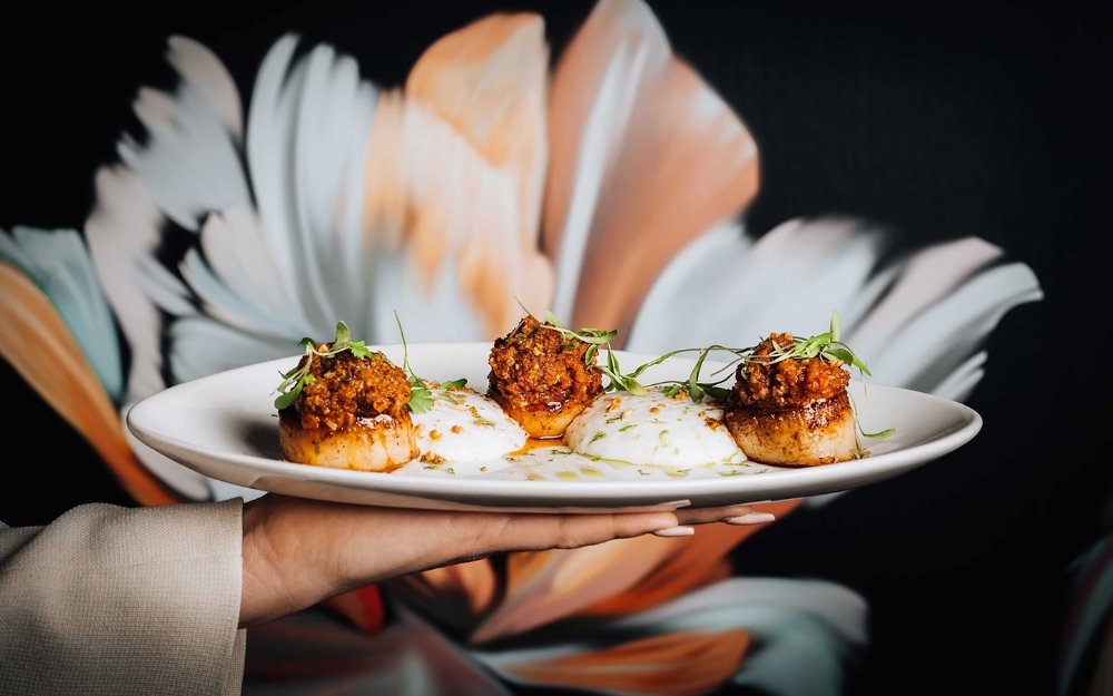 Delicious scallops elegantly plated with vibrant garnishes at Papi Steak