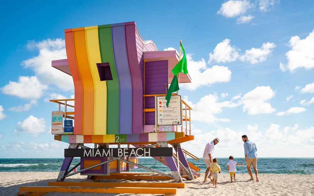 Rainbow lifeguard stand on Miami Beach and family