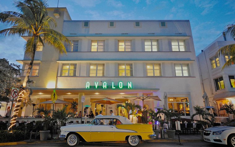 Avalon Hotel on Ocean Drive with a yellow antique car out front Avalon Hotel on Ocean Drive with a yellow antique car out front